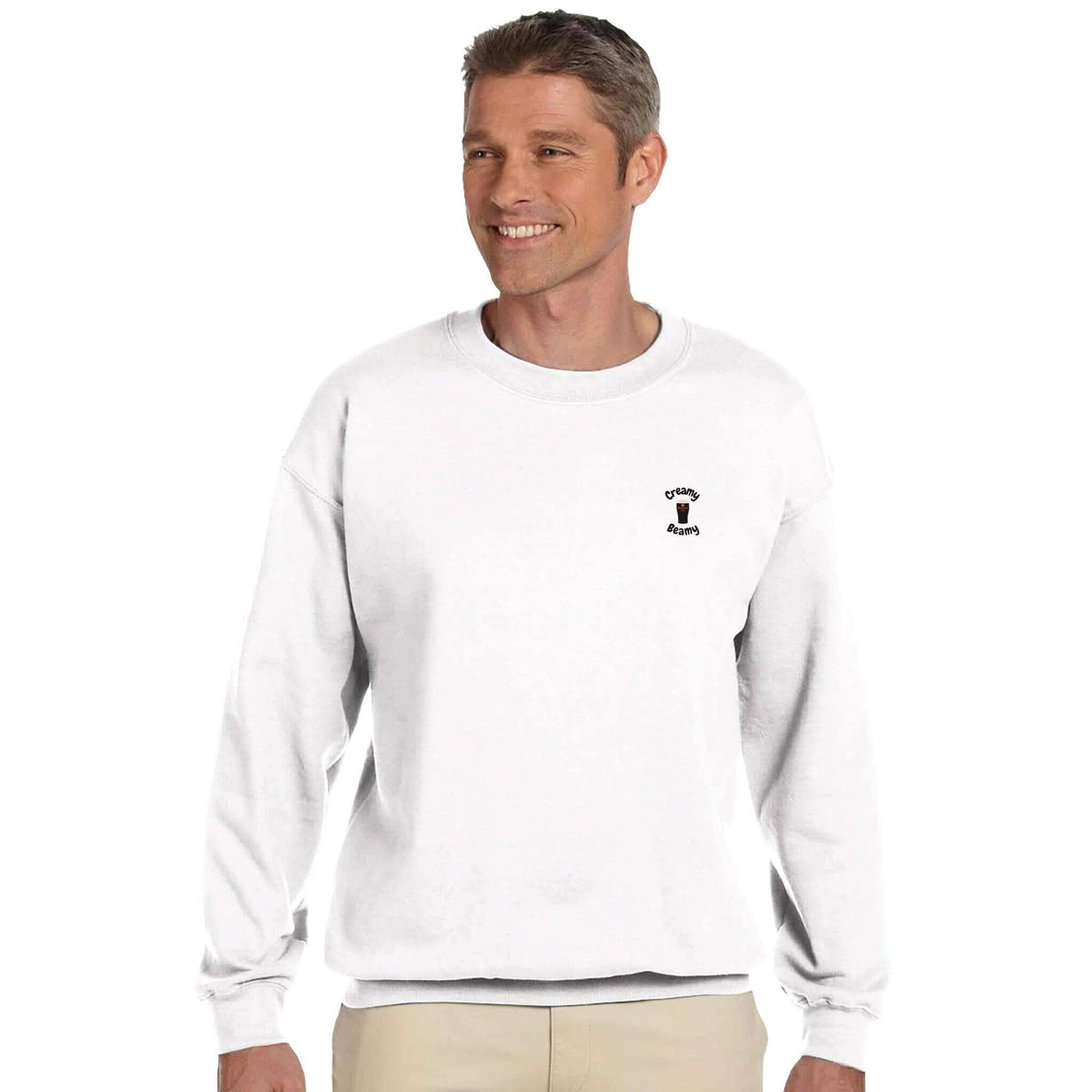 Man wearing a cozy white sweatshirt with a stylish stout logo, perfect for casual outings.