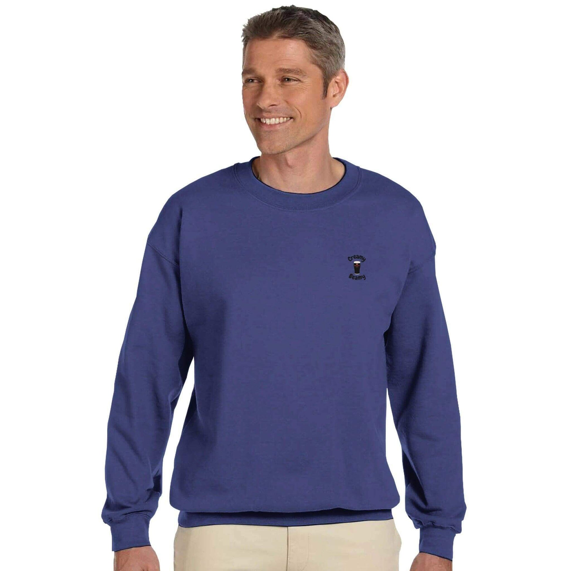 Man wearing a blue Creamy Beamy Beamish Irish Stout sweatshirt, perfect for cozy casual style.