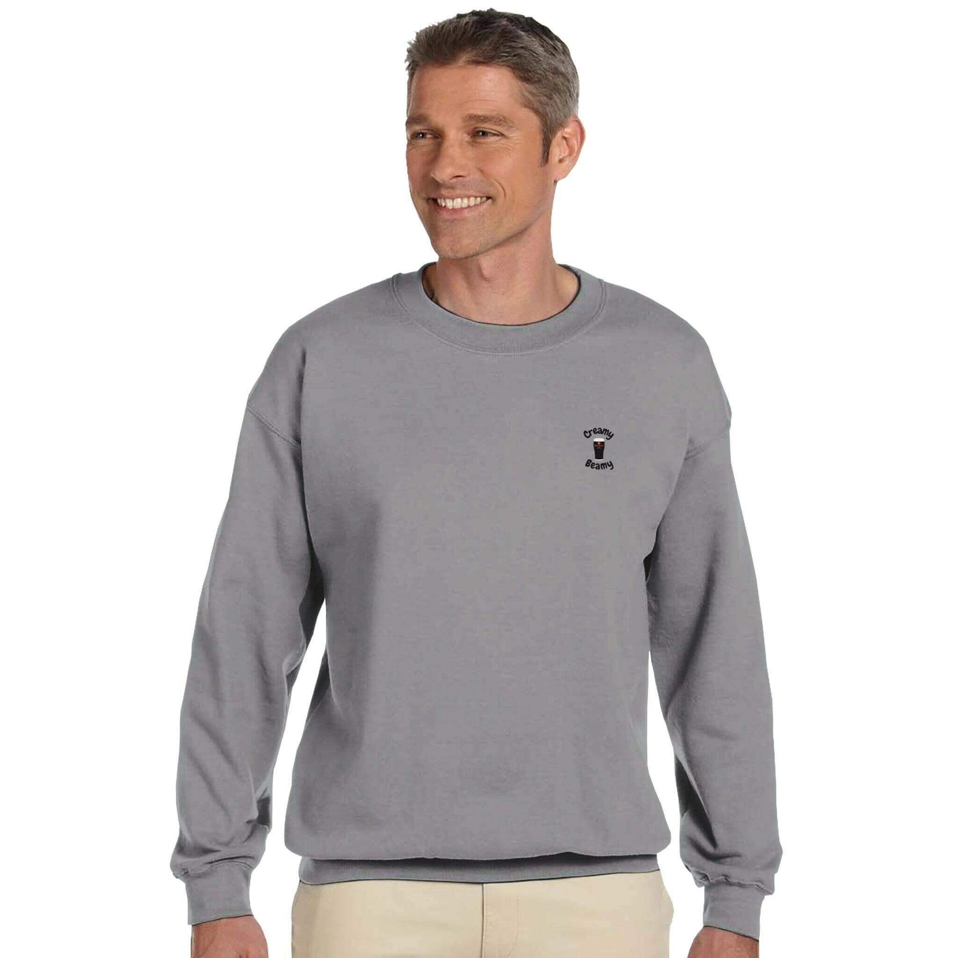 Smiling man wearing a gray Creamy Beamy Beamish Irish Stout Sweatshirt, showcasing comfort and casual style.
