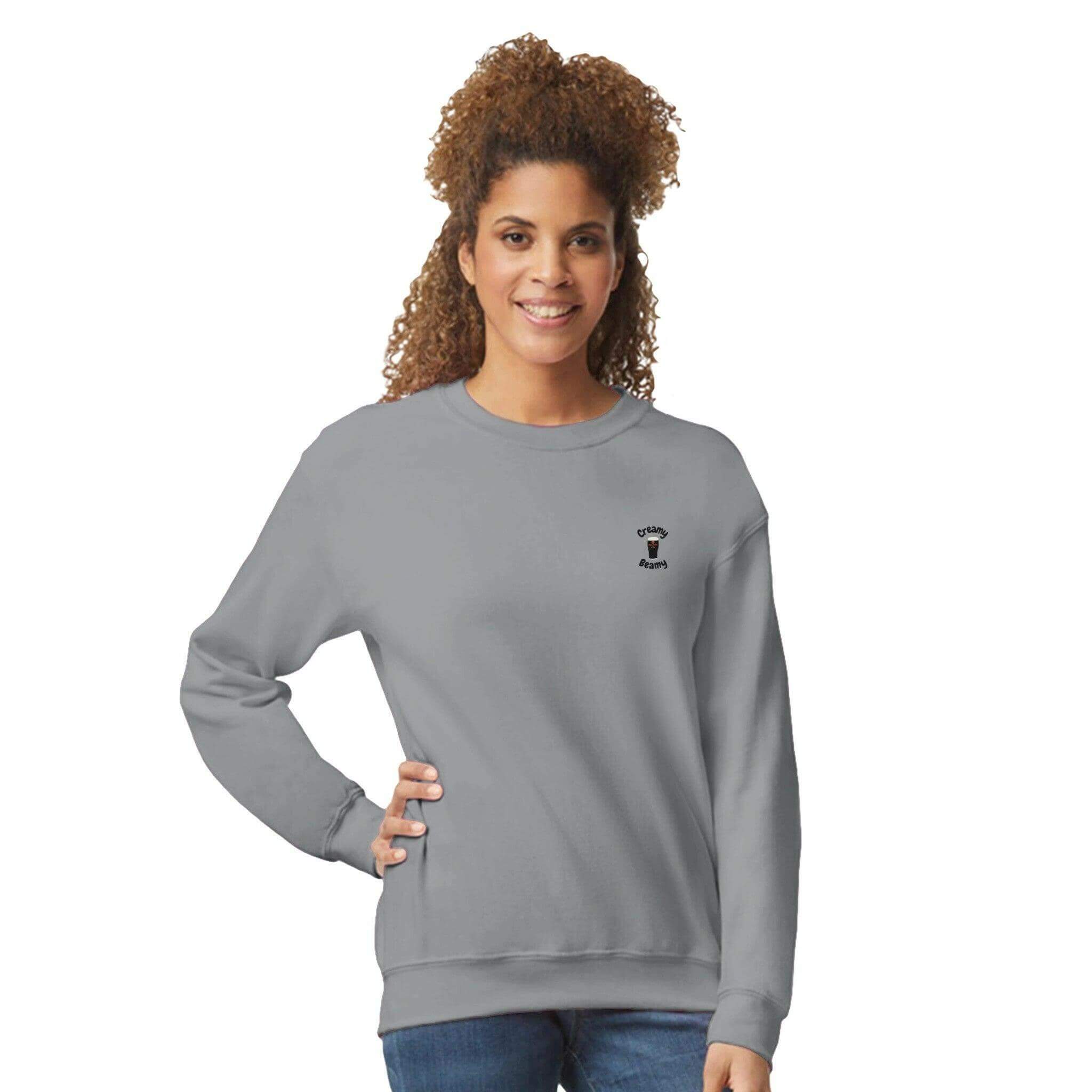 Woman in grey Creamy Beamy Beamish Irish Stout Sweatshirt, showcasing comfort and casual style.