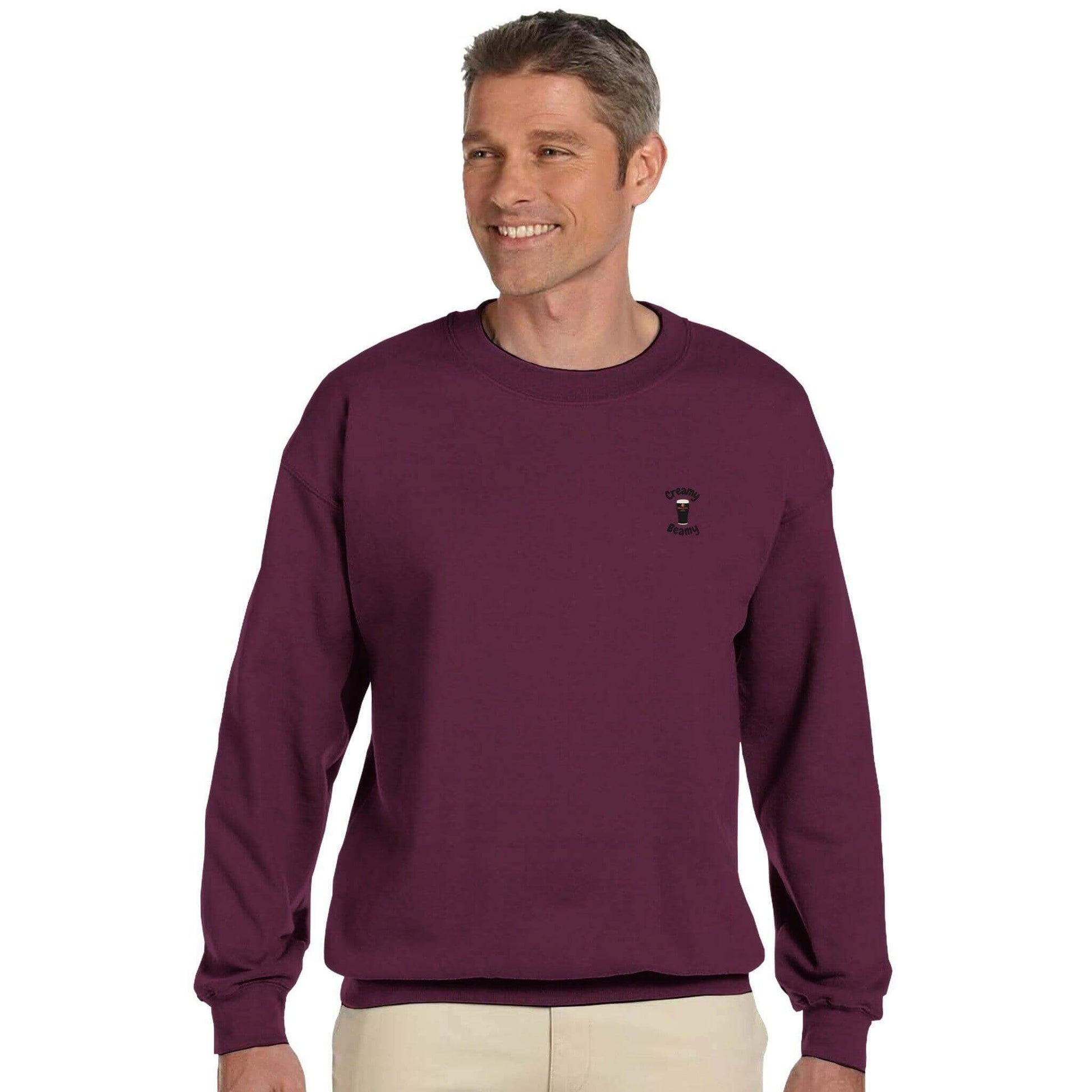 Man wearing a maroon Creamy Beamy Beamish Irish Stout Sweatshirt, perfect for cozy casual outings.