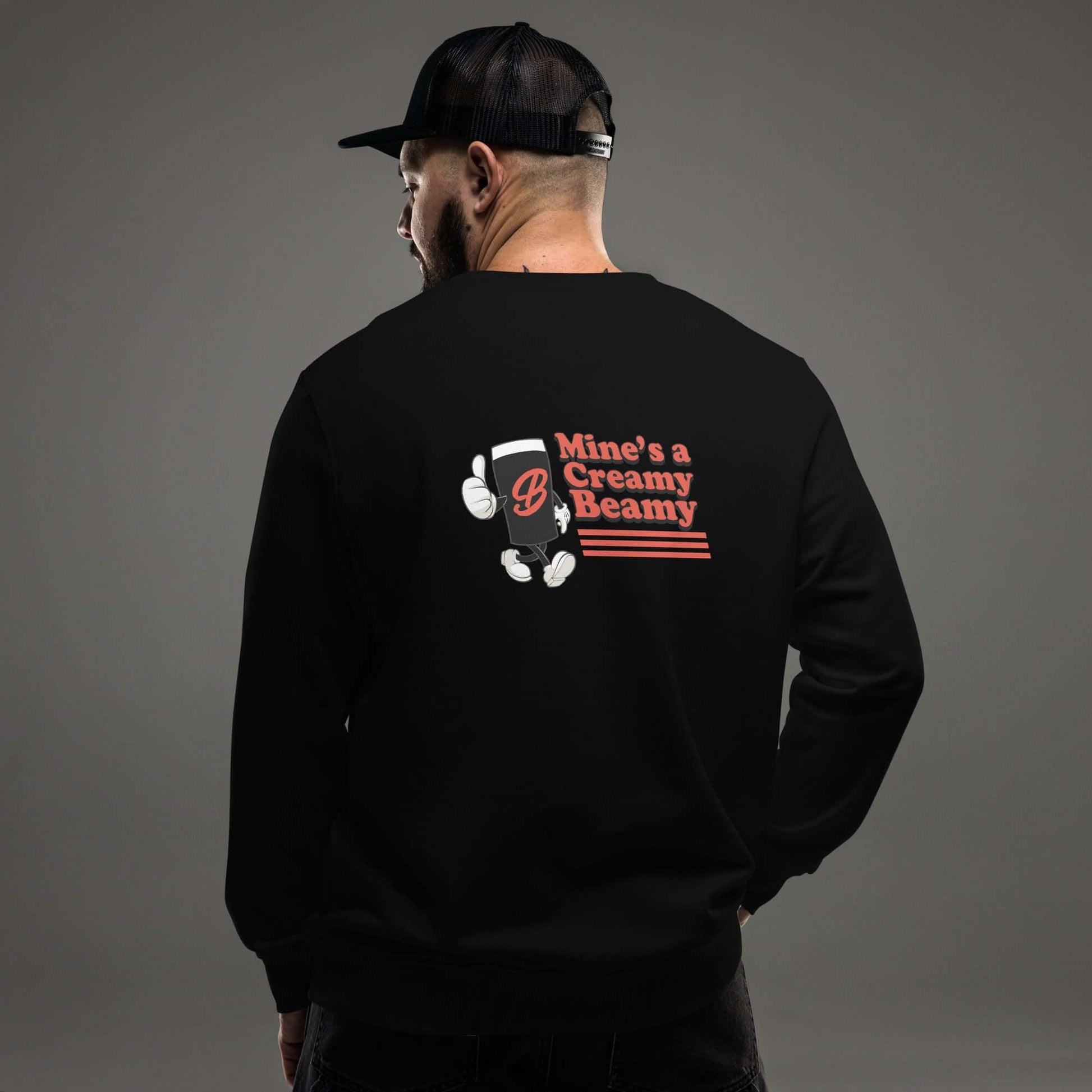 Man wearing a black Creamy Beamy Organic Sweatshirt with vintage pint design on back.