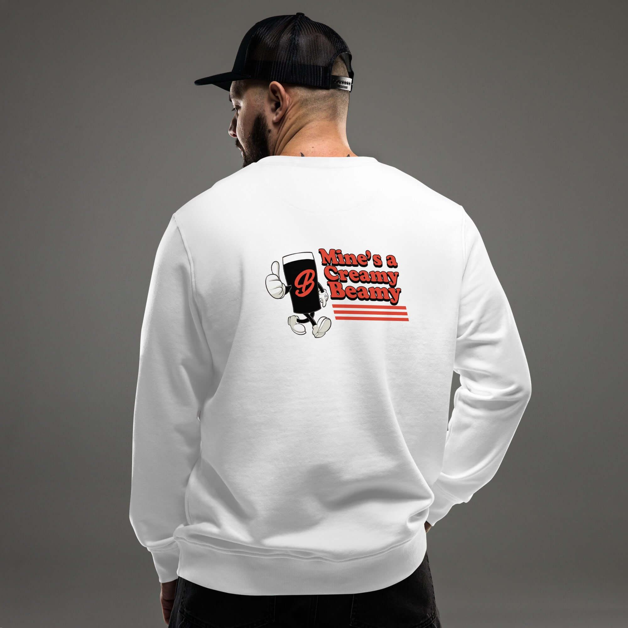 Man wearing a white Creamy Beamy Organic Sweatshirt with retro pint design on the back.