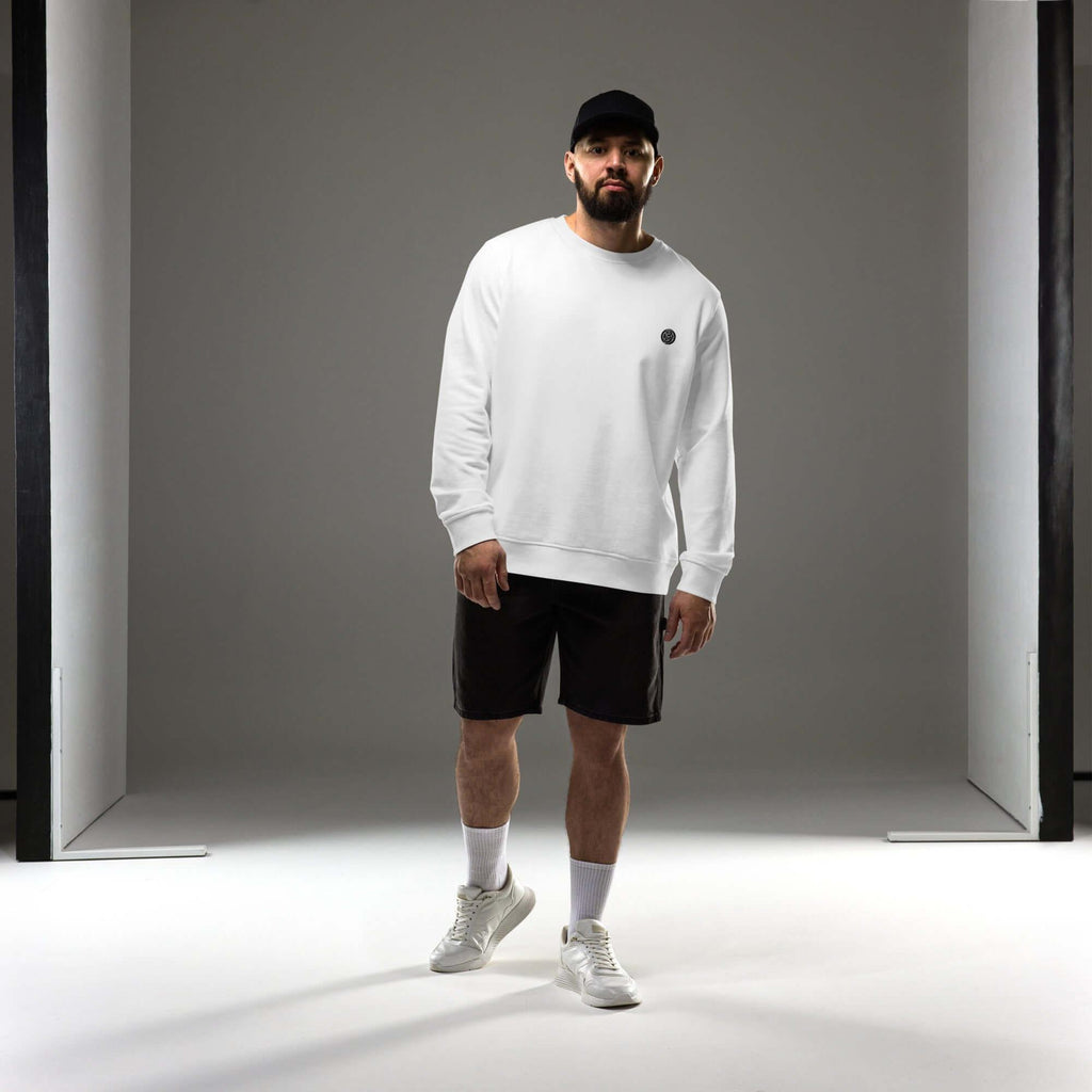 Man wearing a white sweatshirt and shorts, showcasing the Creamy Beamy Organic Sweatshirt's vintage design.