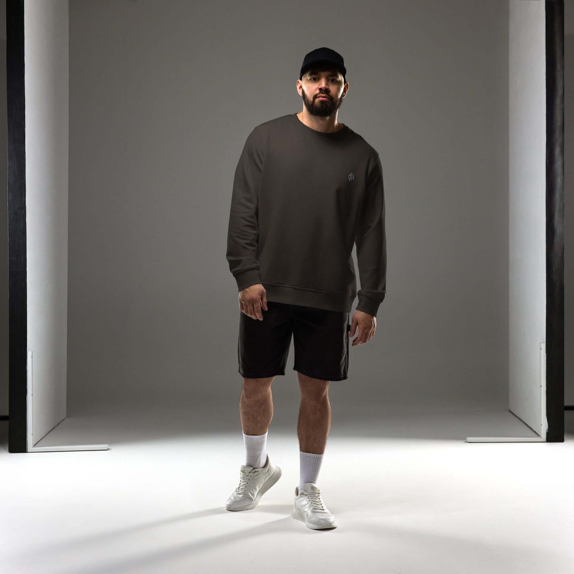 Model wearing a dark green Creamy Beamy Organic Sweatshirt with a relaxed fit and modern style.